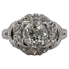 Original Art Deco diamond engagement ring handcrafted in platinum. The ring features an approximately 1.35 carat Old European cut diamond, and 20 surrounding diamonds weighing another .20 carats. The diamonds are graded G color and SI-I1 clarity. The top of the ring measures 11 x 11mm and is currently size 6.5 (can be sized). Vintage Art Deco Rings Engagement, Estate Engagement Ring, Art Deco Diamond Ring Engagement, Vintage Wedding Jewelry, Vintage Art Deco Rings, Antique Engagement Rings Vintage, Antique Jewelry Rings, Platinum Engagement Ring, Platinum Diamond Engagement Rings