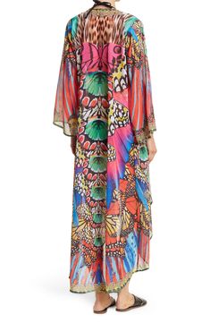 Unleash your free boho spirit in this longline open front kimono styled with vivid patterns. Open front Kimono sleeves All-over print Woven 100% polyester Hand wash cold, line dry Imported Model stats: 5'10", 32" bust, 25" waist, 36" hip. Model is wearing one size. Bohemian Multicolor Printed Cover-up, Multicolor Print Kimono For Spring Beach Cover-up, Multicolor Long Sleeve Cover-up For Beach Season, Multicolor V-neck Kimono For Beach Season, Multicolor Printed Kimono For Beach Cover-up, Multicolor Printed Cover-up With Kimono Sleeves, Multicolor Boho Print Kaftan For Spring, Spring Multicolor Kaftan With Colorful Pattern, Spring Multicolor Boho Print Kaftan