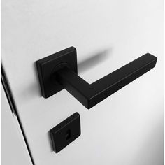 a black handle on a white cabinet door