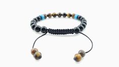 ☮ Men's handmade bracelet features 10mm black onyx and tigers eye beads, and blue agate heishi bead. Bracelet is constructed with nylon and waxed cotton cording for durable and comfortable wear. ☮ Bracelet measures 7 3/4 inches around when it is fully closed but widens to adjust to much bigger wrist sizes. Adjustments to bracelet size can be made, just leave your wrist measurement in the notes to seller at check out if the original size of the bracelet is bigger than your wrist measurement. ☮ Al Adjustable Black Beads Wristband Gift, Casual Black Friendship Bracelets With 8mm Beads, Casual Black Hand Wrapped Bracelets, Casual Black Hand-wrapped Bracelets, Casual Brown Bracelet With Black Beads, Casual Brown Bracelets With Black Beads, Casual Black Beads Wristband Gift, Adjustable Brown Wristband With 8mm Beads, Adjustable 8mm Beads Wristband For Everyday