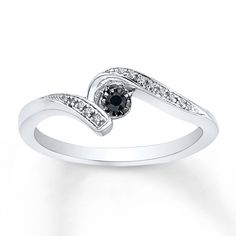 a white gold ring with black and white diamonds