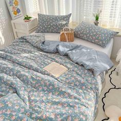 a bed room with a neatly made bed and flowers on the comforter, pillows and rugs