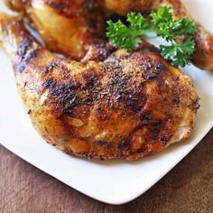 a close up of a chicken on a plate with parsley