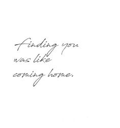 a black and white photo with the words finding you was like earning home written in cursive writing