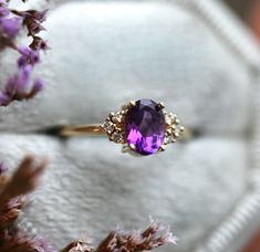 Amethyst and diamond cluster ring features a gorgeous high quality amethyst with sparkly side diamonds. Please select main stone from drop down menu. Price is for main ring only. Please write metal color in the notes at the checkout - 14k rose/yellow/white gold. Details Main stone: 7x5mm natural amethyst, other stones are available at the drop down menu, diamond option will be made with 0.65ct GIA diamond Side stones: white diamonds, color F - G, VS clarity, total carat weight is 0.16ct Accent g Purple Engagement Ring, Purple Engagement Rings, Amethyst Wedding Rings, Amethyst Ring Vintage, Amethyst Engagement Ring, Gold Amethyst Ring, Amethyst Ring Engagement, Ring Purple, Future Engagement Rings