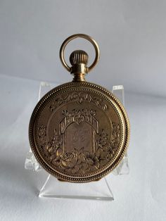 14 Kt solid gold Elgin hunt case pocket watch from 1884. This mechanical hand winding watch is lever set which means the lever on the front must be pulled out in order to set the hands on this style watch. The mechanical movement is in good working condition. The fancy case features a scenic house with floral designs all the way around the back cover The front cover also has fancy floral designs it has initials engraved in the center the engraving is very fancy and hard to decipher I think it is Antique Gold Watches With Chronometer, Victorian Yellow Gold Pocket Watch For Anniversary, Victorian Yellow Gold Pocket Watch With Chronometer, Victorian Gold Watch With Chronometer, Victorian Style Gold Watch With Chronometer, Victorian Yellow Gold Pocket Watch Collectible, Victorian Yellow Gold Pocket Watch For Collectors, Gold Victorian Style Pocket Watch For Formal Occasions, Victorian Engraved Gold Watches