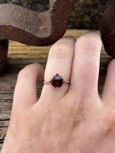 The garnet in this ring has a measurement of approx. 8.5mm The CTW for the diamonds is approx. 0.05. At its widest point the ring has a measurement of approx. 9.9mm The back of the shank has a measurement of approx. 1.85mm. This ring is a size 7 US. Stamped 10k This ring weighs approx. 2.35g Yellow Gold Ring, Yellow Gold Rings, Gold Ring, Statement Rings, Garnet, Gold Rings, Diamonds, Size 7, Yellow Gold