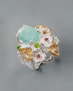 This botanical ring has a very unique style and charm. Those tiny nature inspired details will remind you how awesome and beautiful is our nature! The ring is made with 925 Sterling silver (14K White Gold) and natural gemstones green emerald, Rhodolite, chrome diopside, CZ. The oval emerald in stunning color is framed with roses and flowers. Flowers are coated in 14K rose gold. ♥ The design can be made with gemstones of your choosing ♥ Each order will be gift wrapped beautifully ♥ QUALITY: Each Fine Jewelry Flower Ring For May Birthstone, Green Aquamarine Rings For Anniversary, Flower Shaped Ring With Accent Stones For Gift, Flower Shaped Ring With Accent Stones As Gift, Flower Shaped Rings With Accent Stones As A Gift, Exquisite Birthstone Jewelry Ring, Exquisite Flower Shaped Gemstone Rings, Exquisite Aquamarine Jewelry As Gift, Exquisite Aquamarine Jewelry Gift