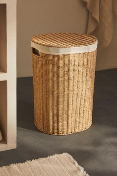 a wicker laundry basket next to a shelf