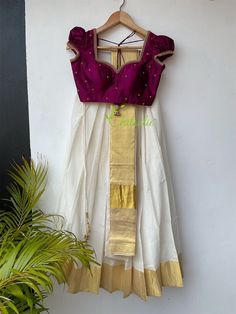 This set consist of 3 pieces- skirt, blouse and dhavani. Fabric and Work: Skirt and blouse: The skirt is made of ivory color half fine Kerala handloom with gold boarder. The blouse is made of soft pure silk fabric. The skirt and blouse is lined with a soft cotton fabric. The blouse hook opening at the back side. The handwork with small puff sleeve gives it a traditional Kerala look. Dhavani: The gold Kasavu boarder of dhavani enhance the beauty of the outfit. If you have any other customization Gold Handloom Choli For Diwali, Diwali Gold Handloom Choli, White Handloom Traditional Lehenga, White Handloom Lehenga With Traditional Drape, White Handloom Lehenga For Festive Occasions, Gold Lehenga In Cotton Silk With Cutdana Detail, Festive White Handloom Lehenga, Gold Handloom Bollywood Choli, Festive Gold Handloom Choli