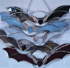 three stained glass bats hanging on a chain