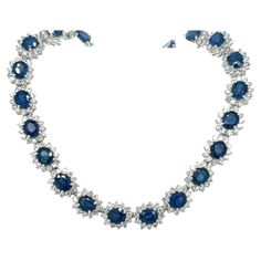 Introducing a circle link 18k white gold choker necklace with natural Blue Sapphires and diamonds. 40 individual links each containing a vivid no heat Blue Sapphire. The Sapphires are oval cut, totaling approximately 36.0 carats total and measuring 6x5 mm. 4-prong set Blue Sapphire with 12 round cut diamonds forming a halo in a shared prong mounting. 480 diamonds totaling approximately 9.60 carats total. Diamonds are H-I color, SI1-SI2 Clarity. Necklace set in 18k white gold, measuring 17 inches Luxury Round Sapphire Diamond Necklace, Fine Jewelry With Sapphire And Single Cut Diamonds, Blue Single Cut Diamond Jewelry In Platinum, Exquisite Sapphire Round Necklace, Exquisite Round Sapphire Necklace, Oval Platinum Necklace With 17 Jewels, Platinum Jewelry With Blue Single Cut Diamonds, Formal Sapphire Necklace With Single Cut Diamonds, Blue Platinum Jewelry With Single Cut Diamonds