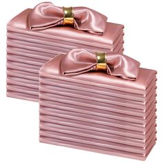 two pink boxes with bows on them are sitting side by side in front of each other