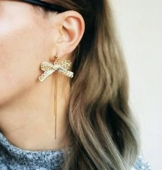 Elegant and unique pair of earrings made with lace-like ribbons in gold plated metal and delicate chain drops. Earwires are raw brass ball studs. ►Length: approx 3  1/2 inches (9cm)►Your earrings come beautifully gift wrapped and ship via priority registered air mail.►Matching necklaces see here: https://www.etsy.com/uk/listing/709002304/tropical-statement-necklace-beaded-bird?ref=shop_home_active_1&frs=1►Tassel earings and tassel necklaces see here: https://www.etsy.com/shop/AlinaandT?secti Gold Earrings With Decorative Bow For Formal Occasions, Gold Ribbon Earrings, Elegant Gold Earrings With Decorative Bow, Adjustable Gold Jewelry With Decorative Bow, Elegant Gold Brass Tassel Earrings, Ribbon Earrings, Beaded Bird, Tassel Earing, Jacket Earrings