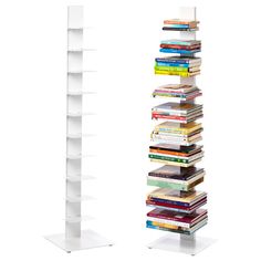 a stack of books sitting next to each other on top of a white book shelf