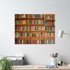 a bookshelf filled with lots of books sitting on top of a wooden desk