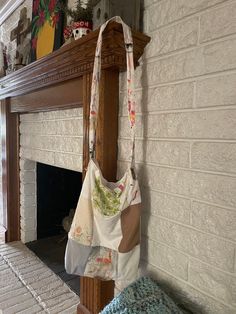 a purse hanging on the wall next to a fireplace