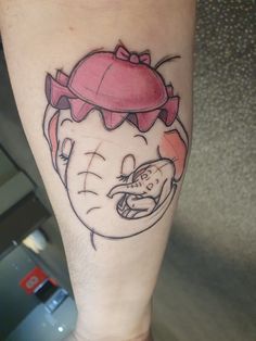 a person with a tattoo on their leg that has an image of a cartoon character