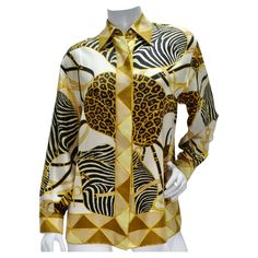 Elevate your wardrobe with the timeless sophistication of this Gucci 1990s Silk Printed Button-Up Shirt. Crafted from luxurious 100% silk, this classic collared shirt exudes luxury and refinement. The shirt features a captivating print in black, brown, white, and yellow, showcasing contrasting zebra and leopard panels intertwined with signature Gucci motifs. This bold yet elegant design adds a touch of glamour and individuality to any ensemble, making it a standout piece in your collection. Acce Luxury Gucci Women's Blouse, Luxury Fitted Gucci Shirt, Gucci Luxury Designer Shirt, Luxury Gucci Blouse For Office, Luxury Gucci Elegant Tops, Fitted Gucci Blouse For Fall, Gucci Formal Button-up Blouse, Gucci Spring Collared Blouse, Gucci Collared Blouse For Spring