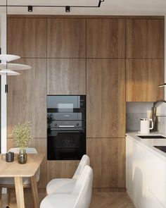 a modern kitchen with wood paneling and white chairs