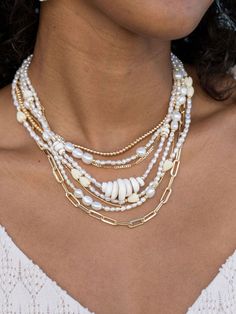 "Beautified with an assemblage of lustrous white freshwater pearl beads, this 18k gold filled pearl necklace alludes to the soothing sands of Hawaii's shores. Wear this gold pearl necklace alone or layered for a classically elegant look. ✦ DETAILS ✦ ✧ Name: Hiwahiwa (HEEvah HEEvah) - precious, beloved, indulged. ✧ Adjustable Length from: 16\"-18\" Inches. ✧ White 3-4mm Freshwater Pearls. ✧ 14kt Gold Filled Components, Extender, and Clasp. ✧ All Ke Aloha Jewelry pieces come packaged thoughtfully, Multi-strand Pearl Beaded Chain Jewelry, White Multi-strand Beaded Necklace With Pearl Drop, Elegant Gold Shell Necklace With Round Beads, White Multi-strand Pearl Chain Necklace, White Multi-strand Beaded Pearl Necklace, White Beaded Multi-strand Pearl Necklace, Pearl Jewelry With Gold Beads For Beach, Beach Pearl Jewelry With Gold Beads, White Multi-strand Necklace With Pearl Pendant