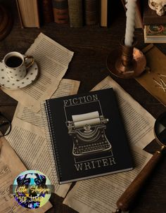 an old fashioned book sitting on top of a table next to a cup and saucer