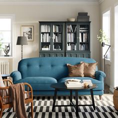 a living room filled with furniture and bookshelves