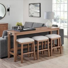 a living room filled with furniture and a large mirror on the wall over a wooden table