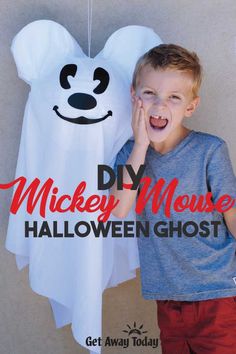 a young boy standing next to a ghost hanging from a line with the words diy mickey mouse halloween ghost on it