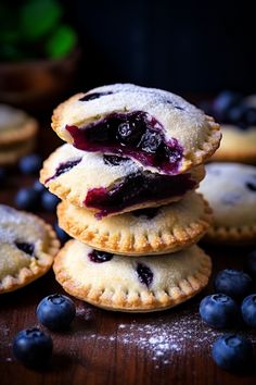 blueberry pies stacked on top of each other with fresh blueberries around them