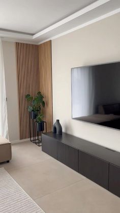 a flat screen tv mounted on the wall in a living room