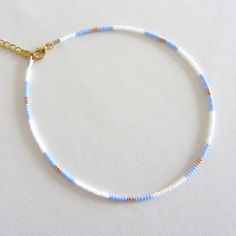 Blue bead choker white beaded choker gold bead choker colorful bead choker seed bead choker boho bead choker summer necklace trendy choker Measure the length of your neck with a measuring tape or you can use any thread, rope, or cable for telephone and after apply the measurements to a regular ruler. These are multi-colored, opaque shiny beads of size 10/0. Choker is 13 inches with a 2 inches adjustable extender chain. 15 inches full length. Summer Seed Bead Bracelet Ideas, Seed Beads Necklace Ideas, Summer Spacer Bead Choker Jewelry, Trendy Blue Choker With Colorful Beads, Gold Round Beads Choker For Summer, Gold Choker With Round Beads For Summer, Blue Tiny Beads Choker For Summer, White Beaded Chain Bracelets For Summer, Summer Blue Beaded Choker