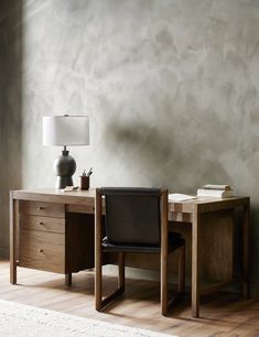 a desk with a lamp and chair in front of it