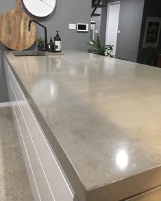 a kitchen counter with a clock on the wall