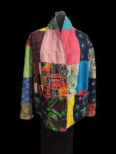 "This jacket is made from a rescued vintage polyester quilt.  The quilt was probably made in the 1970's or 80's, although there is no way to tell for sure.  It measures 25\" from armpit to  armpit.  The sleeve is 29\" long but is made to roll up to fit your arm length.  The coat is 29\"  long.  But most importantly, the coat is reversible, so you get 2 coats in one.  The colour scheme is different on both sides and the maker put a lot of thought into coordinating  the colours.   I usually use cotton quilts, so this one was different to sew with. It is thick, so the seams had to be  sewn on the outside.  But,  when I tried the coat on I was surprised to feel how warm it was: because it is stretchy it kind of melds to your body and feels like a hug." Quilted Retro Outerwear, Retro Quilted Long Sleeve Outerwear, Vintage Quilted Patchwork Jacket, Multicolor Patchwork Quilted Jacket For Winter, Multicolor Patchwork Quilted Winter Jacket, Vintage Quilted Multicolor Outerwear, Vintage Multicolor Patchwork Outerwear, Multicolor Long Sleeve Quilted Jacket, Reversible Jacket