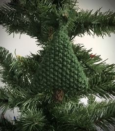 an ornament hanging from the top of a pine tree