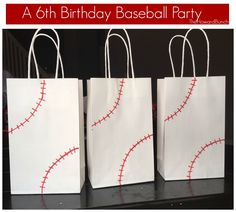 three white bags with red stitches on them and the words, a 6th birthday baseball party