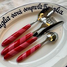 three forks and two spoons on a plate with the words la falfa sa semperia folla