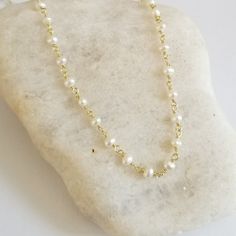 Dainty and oh so pretty, this Freshwater Pearl necklace makes a great everyday boho choker and is ideal for layering with other necklaces in your collection. Available in standard choker length which is 14 inches and sits up high at the neck or your choice of other longer lengths as well.Crafted in natural Pearls. Solid lobster clasp. Pearls are about 3 to 4 mm in size.Details:* Tiny Natural Pearls Rosary Chain* Wire is Sterling Silver with a Rhodium Plating or Gold Version is Sterling Silver wi Handmade Minimalist Pearl Choker Necklace, Minimalist Handmade Pearl Choker Necklace, Delicate Adjustable Everyday Choker, Dainty Handmade Choker For Everyday, Dainty Handmade Everyday Choker, Dainty White Choker With Delicate Chain, Dainty White Beaded Chain Necklace, Festival Gold Necklace With Pearl Chain, Gold Pearl Chain Necklace For Festivals