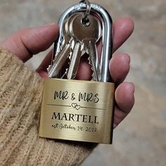 a person holding a bunch of keys in their hand with the words mr and mrs written on them