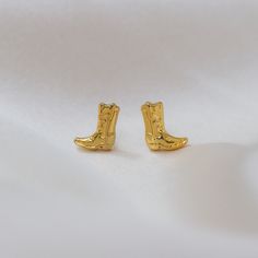 Gold Cowgirl Boot Earrings  - these are the cutest little studs!  Also perfect for Space Cowgirl - Disco Cowgirl bachelorette party gifts!   ♥ Measurements: tiny & sweet!   ♥ Materials: dipped in 12 K gold plating. Posts are titanium - good for sensitive ears! ♥ Packaged in our gift box ♥  Designed by & exclusive to Wildflower + Co. ♥ Imported ♥ Product safety - intended for use by adults only; CA residents - see shop policies for Prop 65 warning ♥ Includes 1 pair of earrings Disco Cowgirl Bachelorette Party, Disco Cowgirl Bachelorette, Cowboy Boot Earrings, Cowgirl Disco, Cowgirl Bachelorette Party, Cowgirl Earrings, Boot Earrings, Cowgirl Bachelorette Parties, Cowgirl Bachelorette