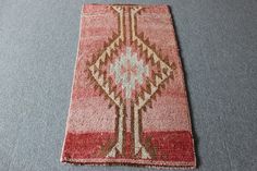 an old rug is laying on the floor with it's end missing from use