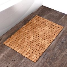 a bathroom with a wooden floor and bathtub