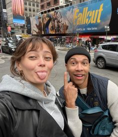 a man and woman standing in the middle of a street