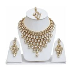 Product Details Base Material Alloy Color- Gold, White Type-Necklace, Earring & Maang Tikka Set Ideal For-Girls, Women Plating-Gold-Plated Net Quantity-1 1 Necklace, 2 Earring, 1 Maang Tikka Collection- Contemporary Occasion- Wedding & Engagement Traditional Kundan Dulhan Bridal Jewellery Set This Traditional Bridal Jewelry Combo Necklace Set Is The Best Set Of Accessory To Enhance Your Beauty And Compliment You On Your Wedding Day. Made Of Brass Alloy And Kundan Settings, The Classic Ensemble W Dulhan Bridal, Jewelry Combo, Traditional Bridal Jewelry, Maang Tikka Set, Bridal Jewellery Set, Maang Tikka, Enhance Your Beauty, Jewellery Set, Jewelry Stand