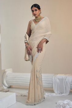 Eggshell pre-draped saree with pearl embroidery details in georgette base. Paired with a padded sleeveless blouse.
Components: 2
Pattern: Embroidered
Type Of Work: Pearl
Neckline: V Neck
Sleeve Type: Sleeveless
Fabric: Georgette, Net
Color: Beige
Other Details: 
Attached lining
Blouse length: 12.5 inches
Occasion: Mehendi and Haldi - Aza Fashions Elegant Georgette Pre-draped Saree With Zari Work, Traditional Georgette Pre-draped Saree With Pearl Embroidery, Elegant Pre-draped Saree With Sheer Dupatta In Georgette, Elegant Pre-draped Georgette Saree With Sheer Dupatta, Elegant Fitted Pre-draped Saree With Pearl Embroidery, Elegant Saree With Pearl Embroidery In Traditional Drape, Elegant Blouse Piece With Pearl Embroidery In Traditional Drape, Elegant Saree With Pearl Embroidery And Traditional Drape, Elegant Saree With Pearl Embroidery