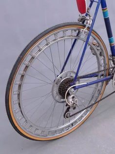 a blue and gold bicycle with red seatposts