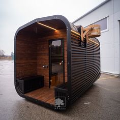 an outdoor sauna is made out of wood and metal