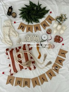 christmas decorations laid out on top of a bed