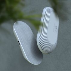 a close up view of an air purificater on a wall with a plant in the background